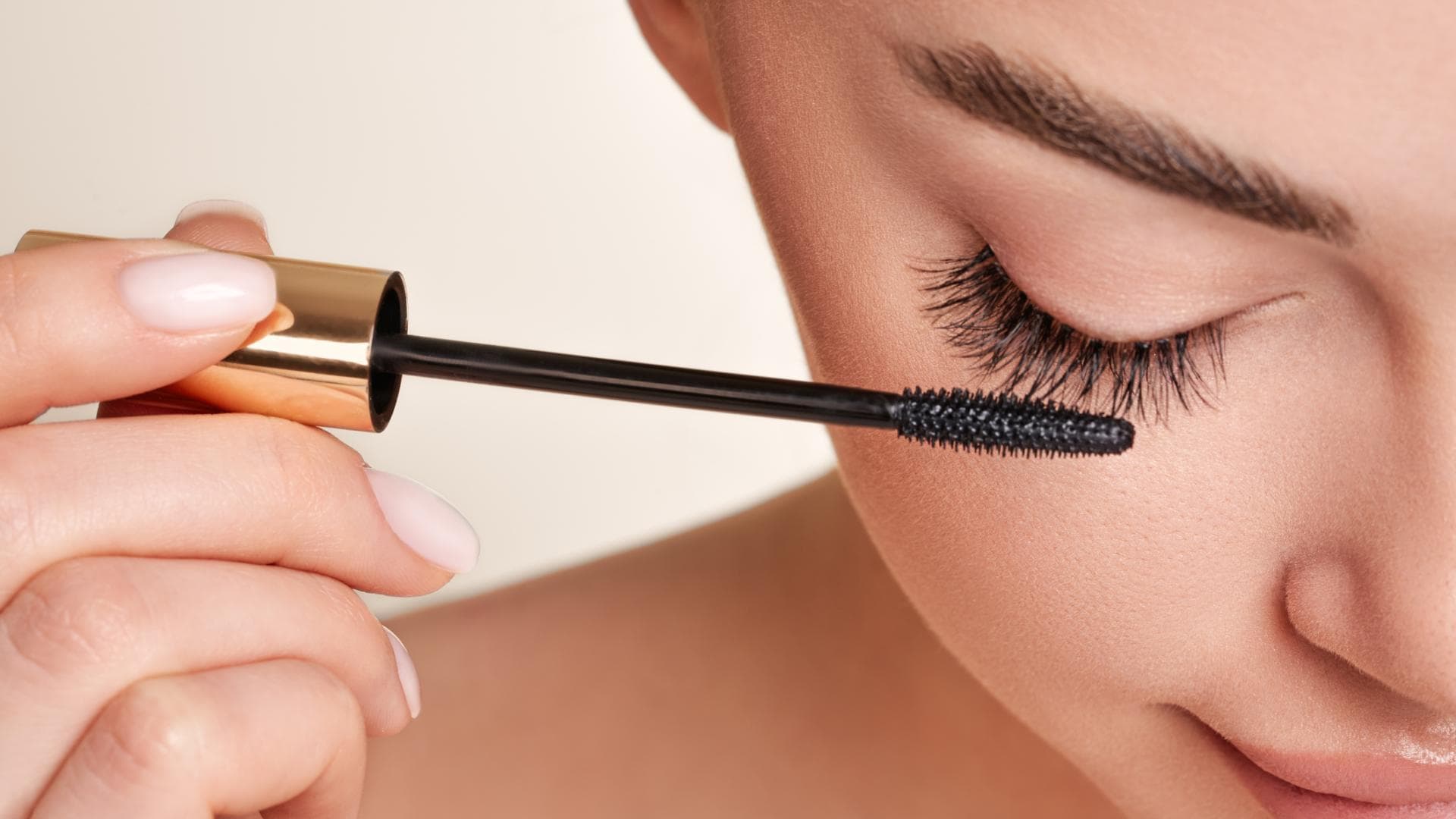 Frau tuscht Wimpern