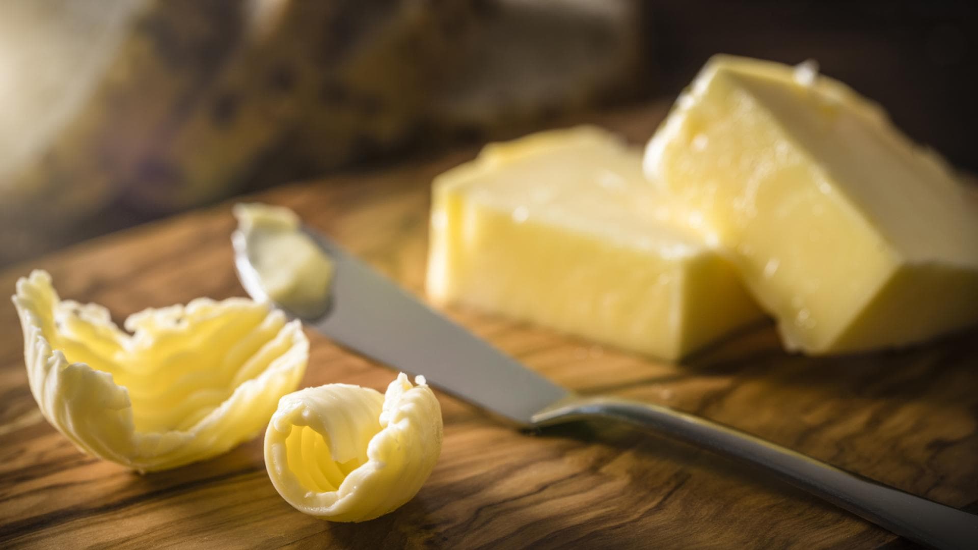 Nahaufnahme von Margarine und Buttermesser auf Holzbrett