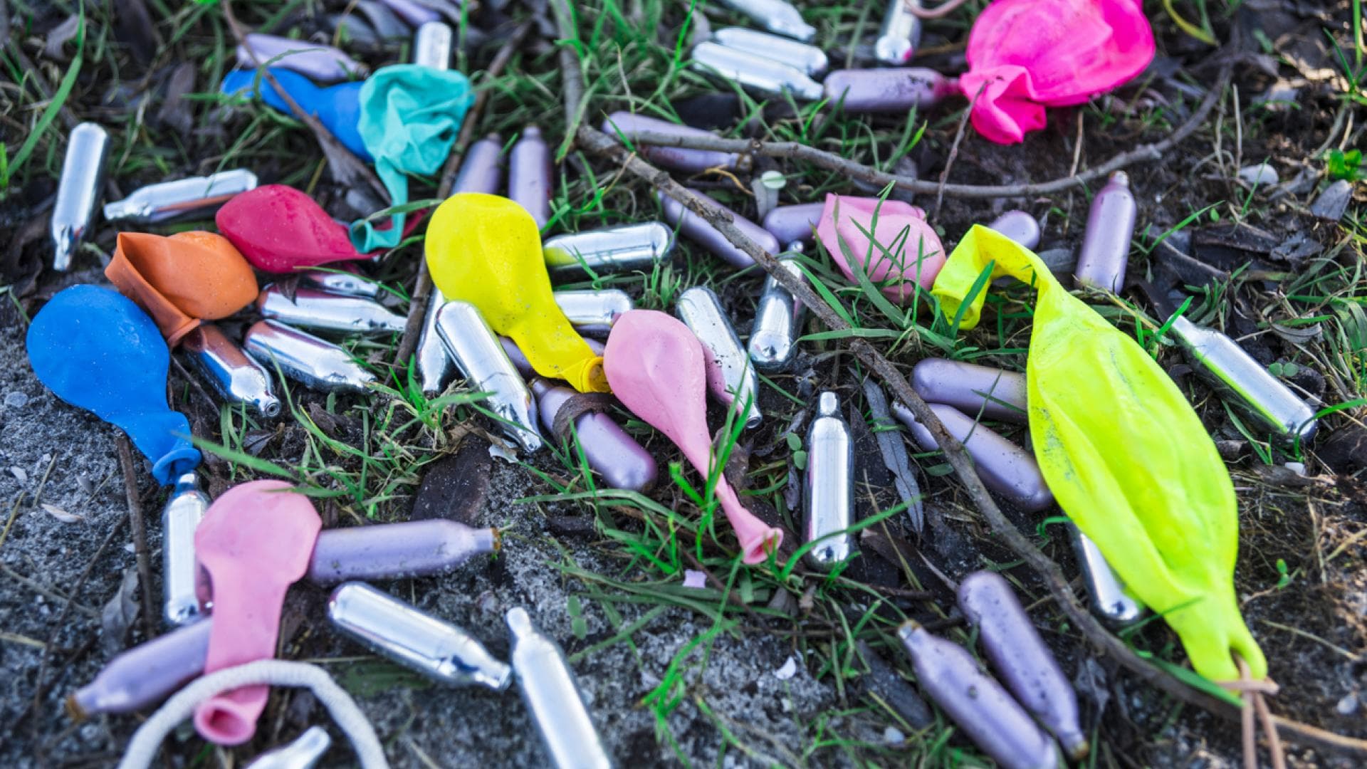 Lachgas ist zur Partydroge geworden Lachgaskartuschen und leere Luftballons nach einer Party auf dem Boden