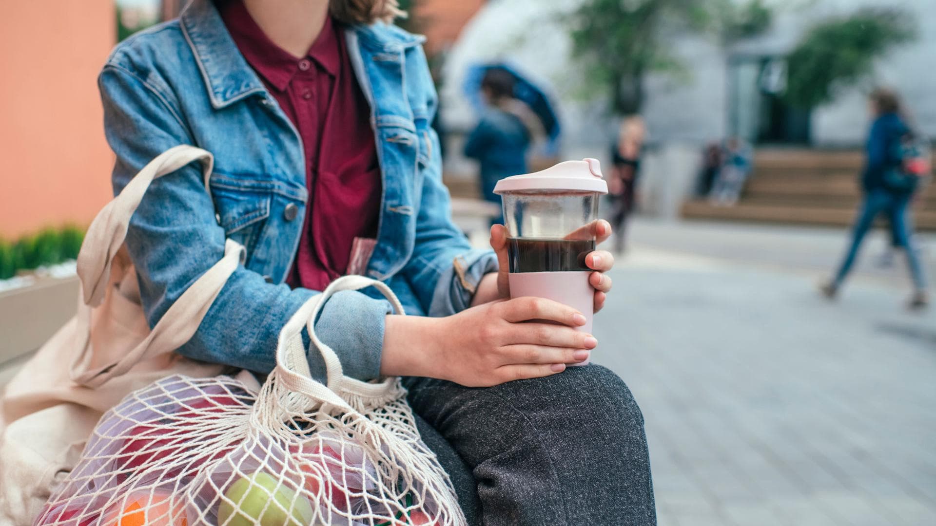 Nachhaltige_Alternativen Frau mit nachhaltigen Alternativen mit Obstnetz und Kaffeebecher
