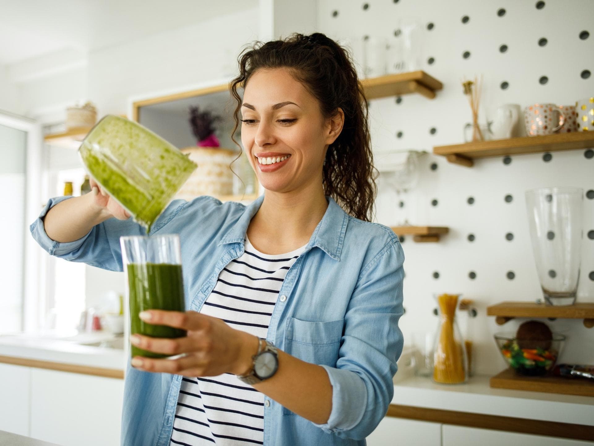 Frau bereitet Smoothie zu Frau bereitet Smoothie zu