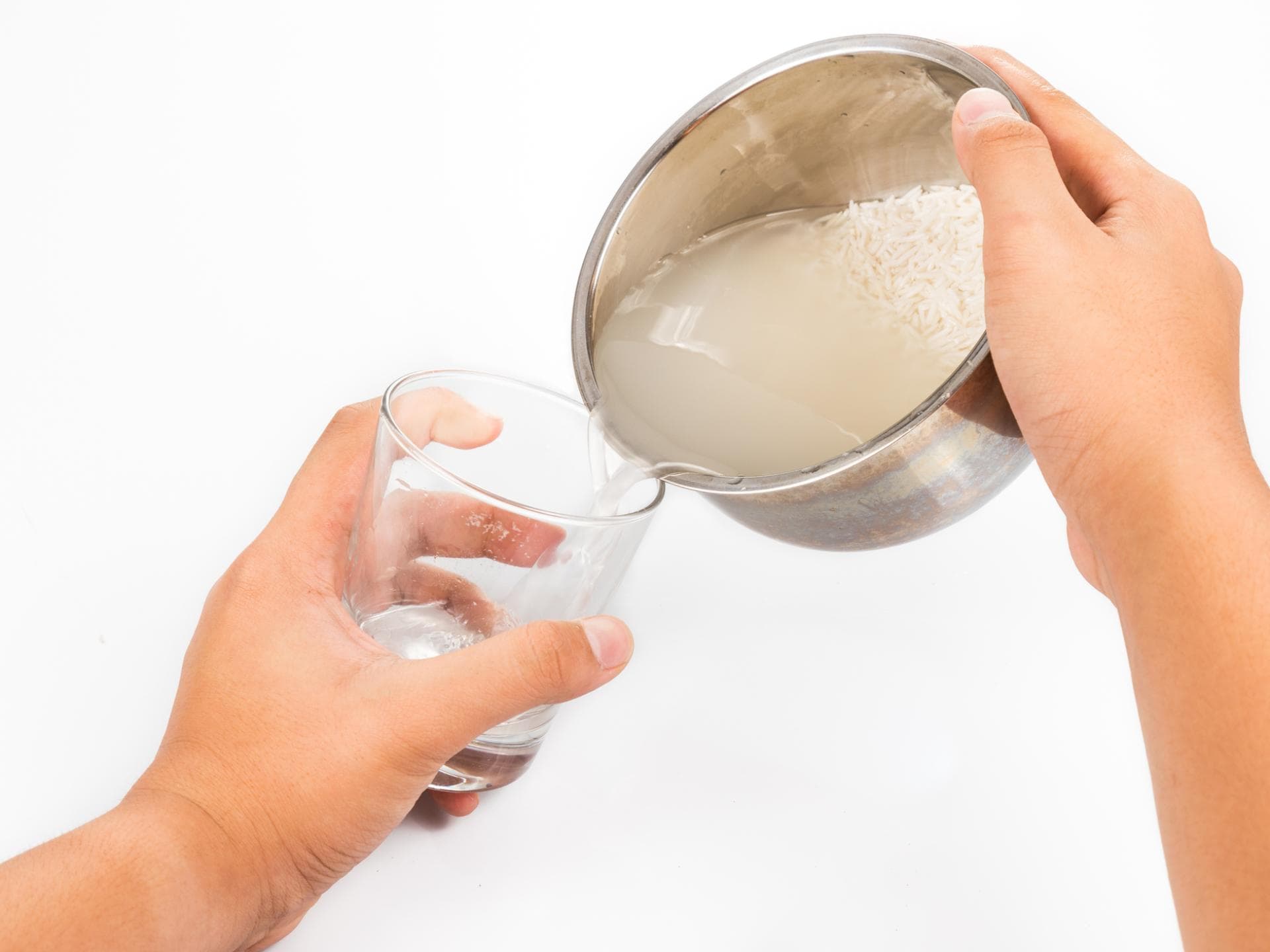 Reiswasser wird in Glas gefüllt