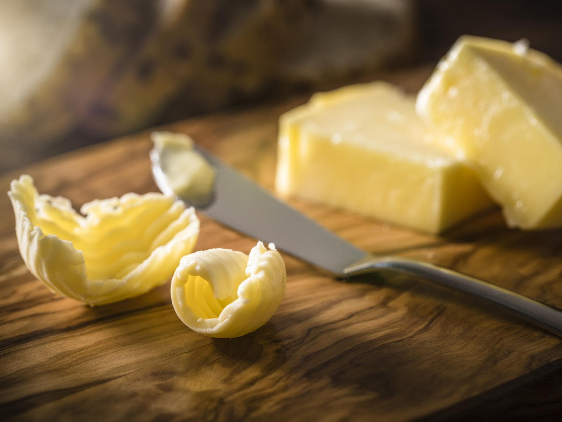Nahaufnahme von Margarine und Buttermesser auf Holzbrett