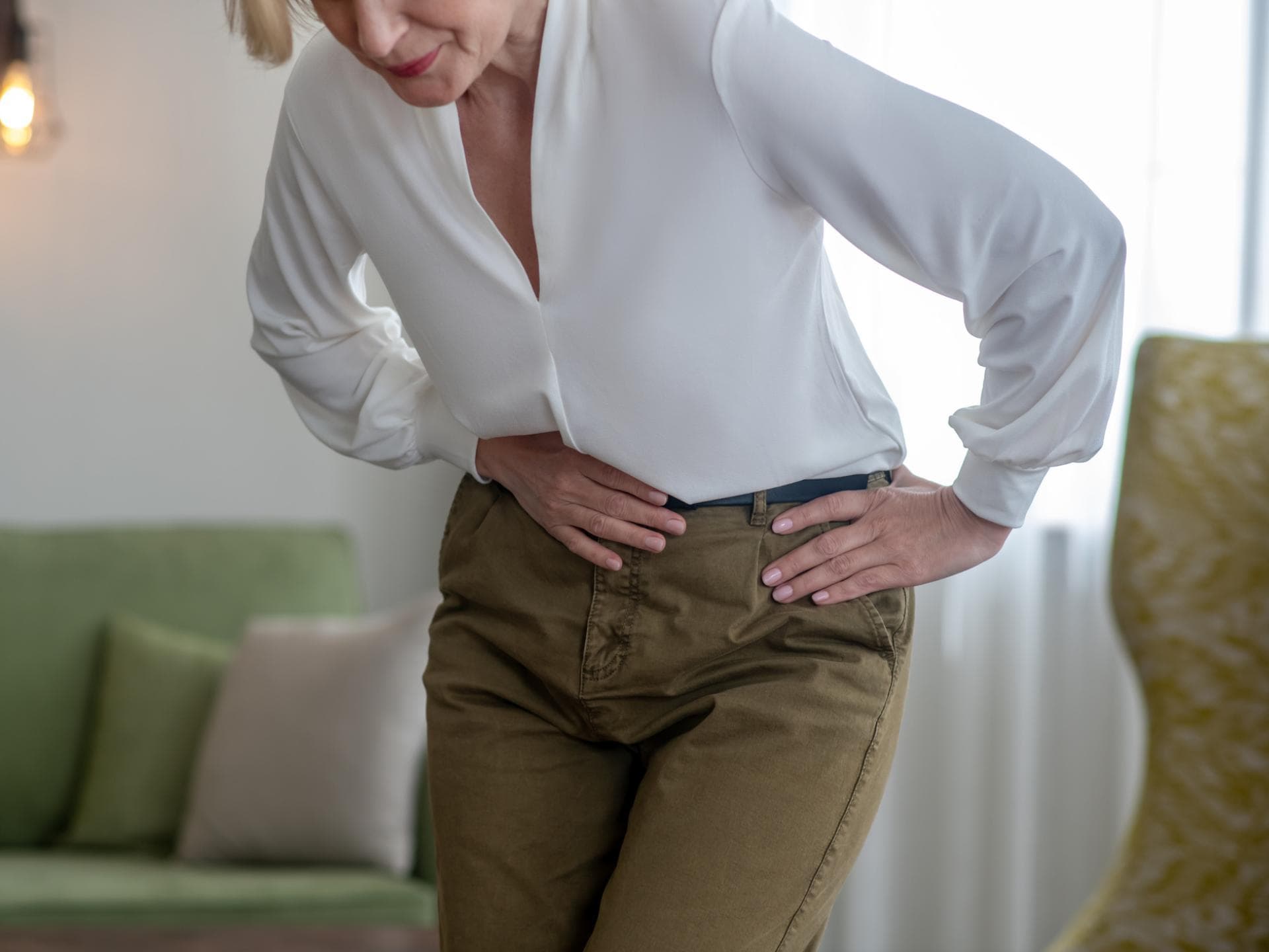 Ältere Frau hält sich den Bauch