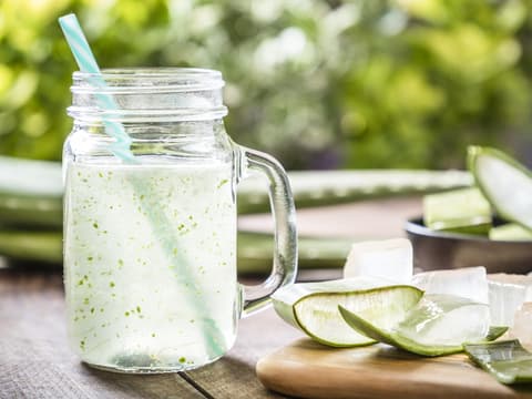 frischer Aloe Vera Saft in Glas mit Strohhalm