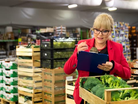Kontrolleurin prüft Lebensmittel im Markt