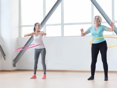 Zwei Frauen machen Hula-Hoop