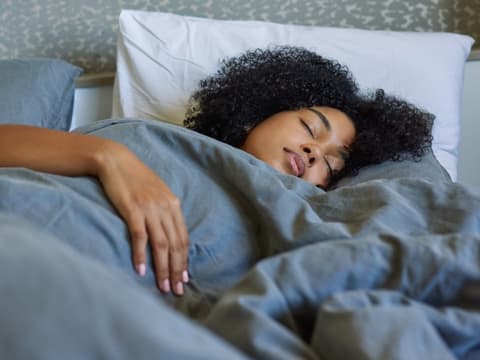 Frau schläft im Bett 