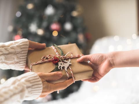 Person reicht ein Geschenk