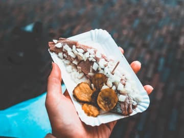 Hering mit Zwiebeln und Gurken auf einer Pappschale Hering mit Zwiebeln und Gurken auf einer Pappschale